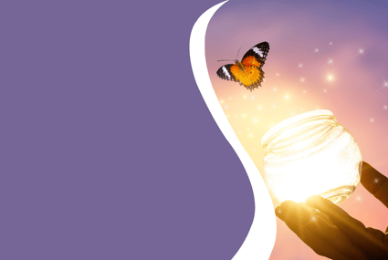 A butterfly being released from a brightly lit jar.