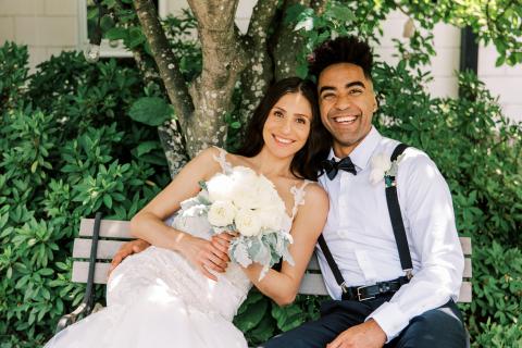 Bride and Groom smiling at the camera