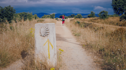 a pilgrim walking a path on the Camino del Santiago